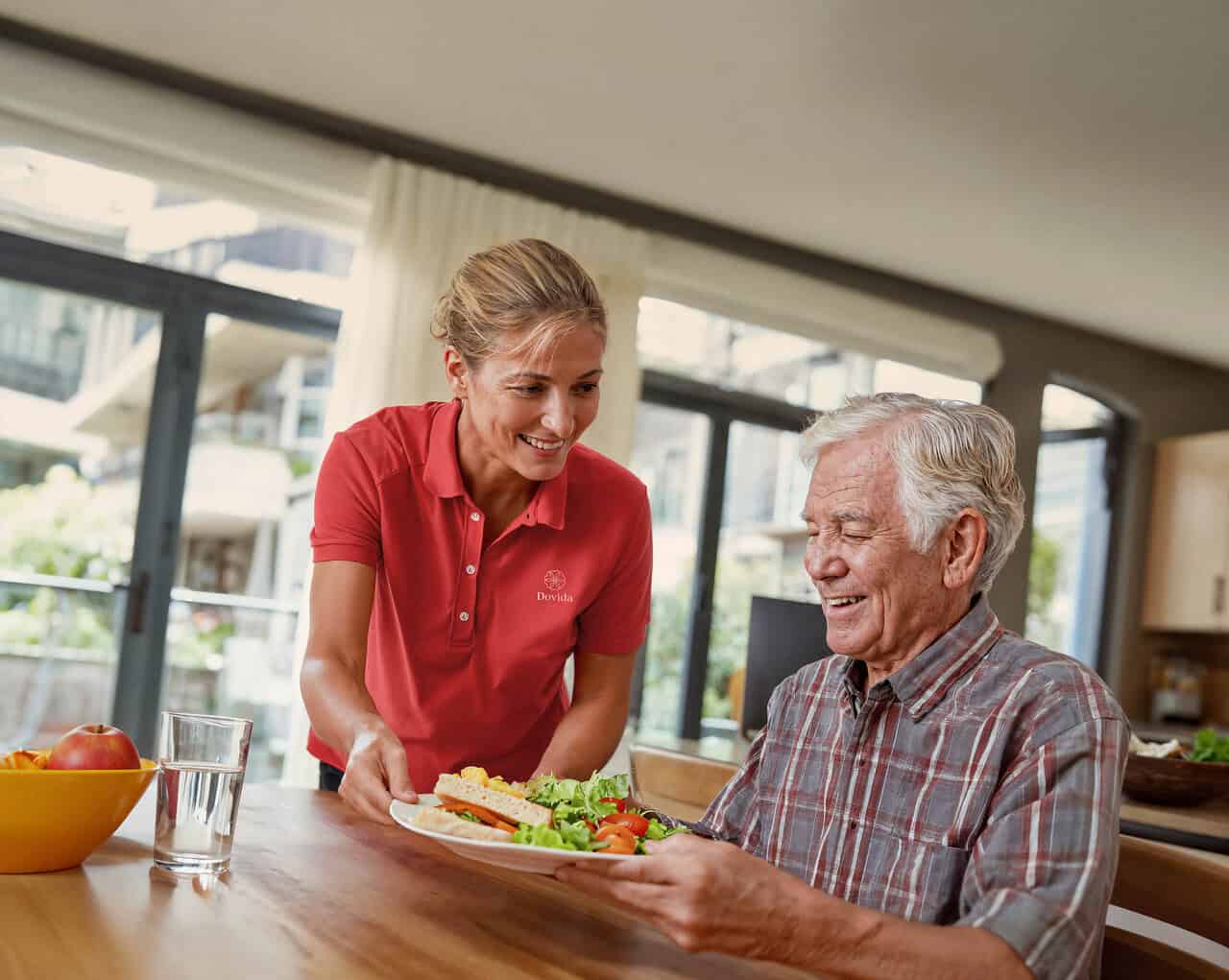 Caregiver sharing a conversation with an older adult at home